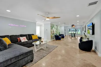 a living room with a couch and a table at Water Front Home with Boat Dock Hot Tub Roof Top Fire Pit in Fort Lauderdale