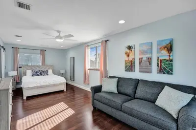 a living room with a couch and a bed at Water Front Home with Boat Dock Hot Tub Roof Top Fire Pit in Fort Lauderdale