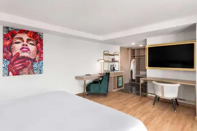 a hotel room with a bed and a flat screen tv at Dolce by Wyndham Hollywood in Hollywood