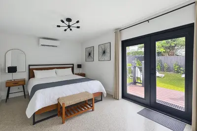 a bedroom with a bed and a sliding glass door at Private King Suite in Miami in Miami