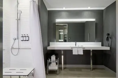 a bathroom with a sink and a mirror at AC Hotel Miami Wynwood in Miami