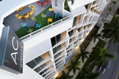 an overhead view of a building with chairs and palm trees at AC Hotel Miami Wynwood in Miami