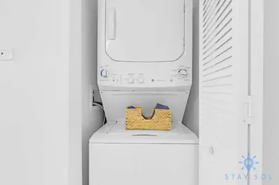 a washing machine with a basket on top of it at MODERNResortBALCONY in Hallandale Beach