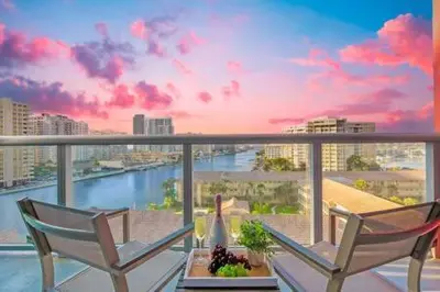 two chairs and a table on a balcony with a view at Pool - Apartment with Balcony - Gym - Near Beach in Hallandale Beach