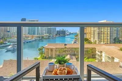 a tray of pastries on a balcony with a view of a river at Pool - Apartment with Balcony - Gym - Near Beach in Hallandale Beach