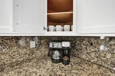 a kitchen counter with a coffee maker in a cupboard at Hot Tub! Roof Top! Firepit! Boat Dock! in Fort Lauderdale