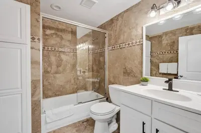 a bathroom with a toilet and a shower and a sink at Hot Tub! Roof Top! Firepit! Boat Dock! in Fort Lauderdale