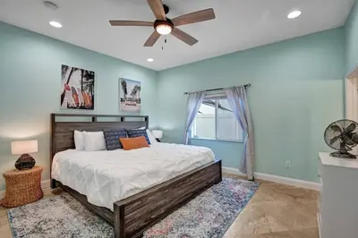 a bedroom with a bed and a ceiling fan at Hot Tub! Roof Top! Firepit! Boat Dock! in Fort Lauderdale