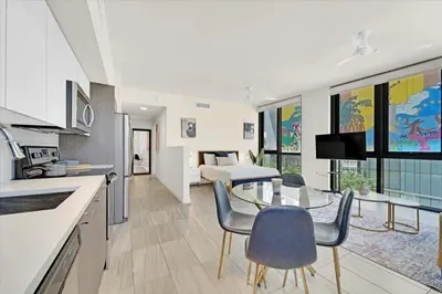 a kitchen and living room with a table and chairs at Devereaux Miami Luxury One-Bedroom and Studios in Miami