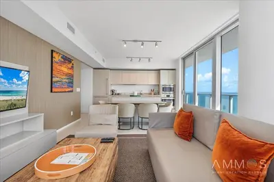 a living room with a couch and a table at Ocean Views Perfect Location Resort Amenities in Hallandale Beach
