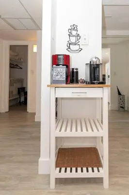 a table with a coffee maker on it in a room at Stunning & Spacious Resort-Style Condo Across From Beach! in Miami Beach