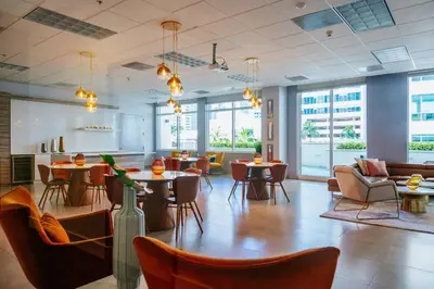 a large room with tables and chairs and windows at Brickell, Miami Home in the Sky! in Miami
