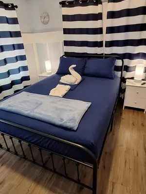 a bed with blue sheets and swans on it at Blue Little Havana in Miami