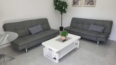 a living room with two couches and a table at Funston in Hollywood