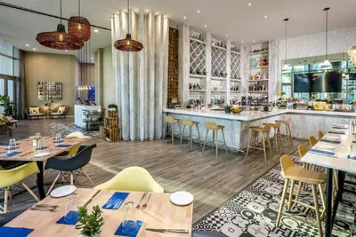 a restaurant with tables and chairs and a bar at Lyfe-1005 in Hollywood
