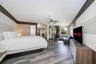 a bedroom with a bed and a flat screen tv at Deco Boutique Hotel in Fort Lauderdale