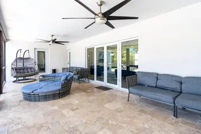 a living room with couches and a ceiling fan at Hollywood Paradise Luxury 4BR 3BA Home and Outdoor Fun with Heated Pool in Hollywood