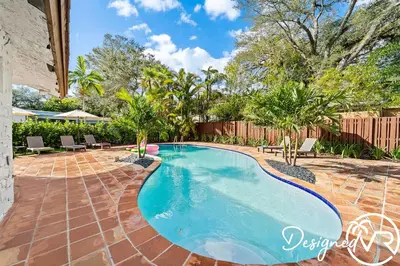 a swimming pool in a yard with chairs and trees at Villa wPool Firepit BBQ in Hollywood