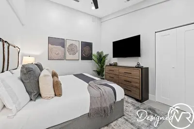 a white bedroom with a bed and a flat screen tv at Villa wPool Firepit BBQ in Hollywood