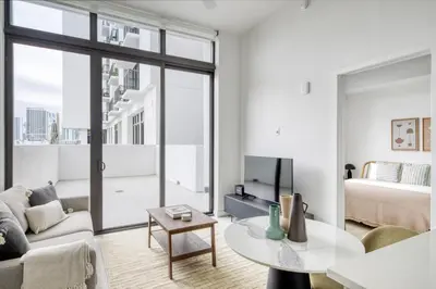 a living room with a couch and a bed and a table at Wynwood 1br w gym pool lounge nr Midtown MIA-35 in Miami