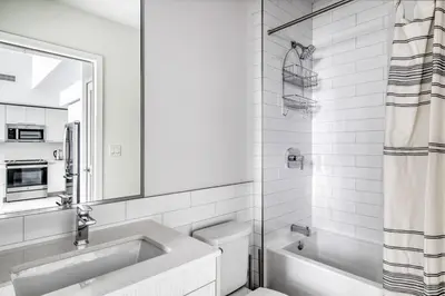 a white bathroom with a sink and a toilet at Wynwood 1br w gym pool lounge nr Midtown MIA-35 in Miami