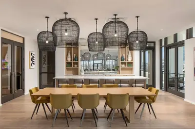 a dining room with a table and chairs and chandeliers at Wynwood 1br w gym pool lounge nr Midtown MIA-35 in Miami