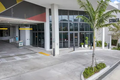 a palm tree in front of a building at Wynwood 1br w gym pool lounge nr Midtown MIA-35 in Miami
