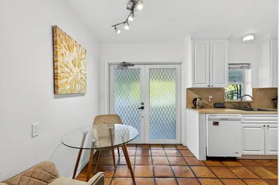 a kitchen with a glass table in a kitchen at Sunny 2-Bedroom Miami Retreat with a Bright, Spacious Living Area & Relaxing Outdoor Seating in Fort Lauderdale