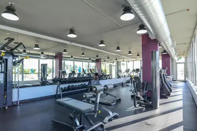 a gym with rows of treadmills and machines at Decoplage Paradise - Main Home in Miami Beach
