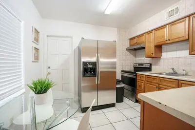 a kitchen with a stainless steel refrigerator at Modern 2 Bedroom in the Heart of Wynwood Art District in Miami