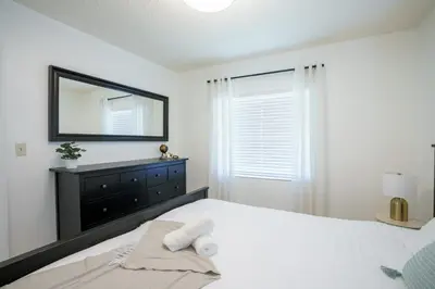 a bedroom with a bed with a mirror and a dresser at Modern 2 Bedroom in the Heart of Wynwood Art District in Miami