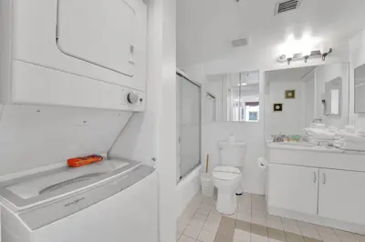 a white bathroom with a sink and a toilet at Impressive Unit in the heart of Brickell W Parking in Miami