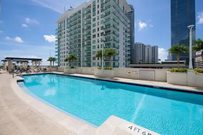 a large swimming pool in front of a tall building at Impressive Unit in the heart of Brickell W Parking in Miami