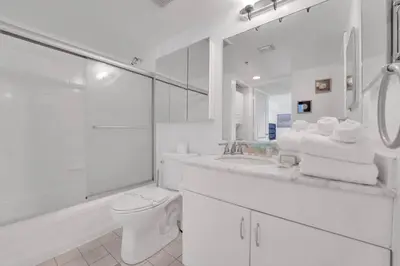 a white bathroom with a toilet and a sink at Impressive Unit in the heart of Brickell W Parking in Miami