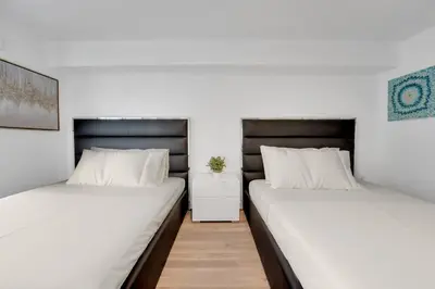 two beds sitting next to each other in a room at Impressive Unit in the heart of Brickell W Parking in Miami