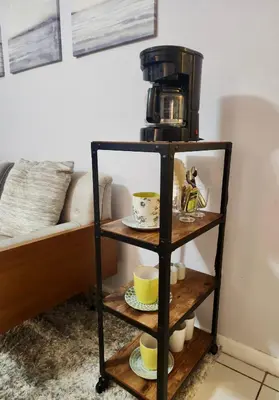 a coffee maker on a shelf next to a couch at Coral Gables / Coconut Grove area FREE parking in Miami