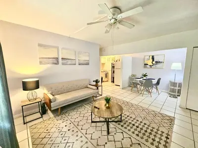 a living room with a couch and a table at Coral Gables / Coconut Grove area FREE parking in Miami