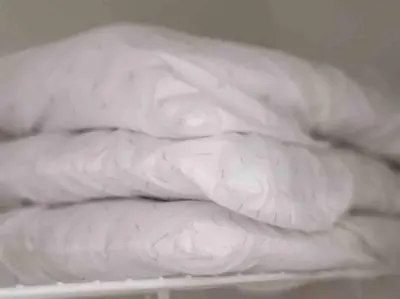 a pile of white towels sitting on a shelf at LOCATION! Apartment in Coconut Grove with parking in Miami