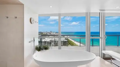 a white bathroom with a tub and a view of the ocean at Oceanfront Private Penthouse Condo at The Setai -3909 in Miami Beach