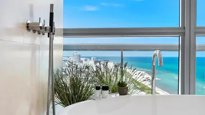a bathroom with a tub and a window with the ocean at Oceanfront Private Penthouse Condo at The Setai -3909 in Miami Beach