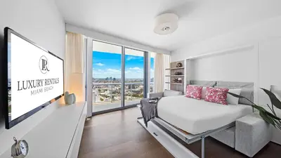 a bedroom with a bed and a large window at Oceanfront Private Penthouse Condo at The Setai -3909 in Miami Beach