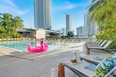 a swimming pool with a pink flamingo in a city at Apartment with Balcony, Gym, Pool in Hallandale Beach