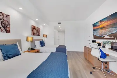 a hotel room with a bed and a desk at Modern Resort with Balcony - Near Beach - Pool in Hallandale Beach