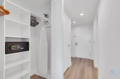 a white room with white shelves and a tv at Modern Resort with Balcony - Near Beach - Pool in Hallandale Beach