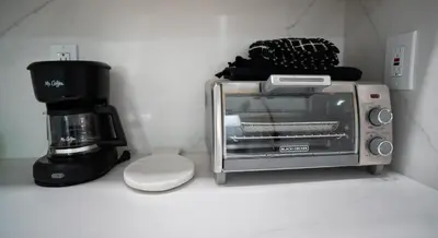a toaster oven sitting next to a coffee maker at Stylish Studio Near Wynwood & Design District in Miami