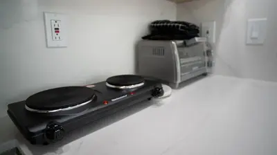 a stove with two burners in a kitchen with a microwave at Stylish Studio Near Wynwood & Design District in Miami