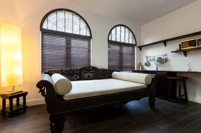 a living room with a couch and two windows at Vive Zen Master Suite for 4 Guests in Miami
