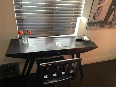 a desk in a room with a window with a lamp at Vive Zen Queen Room in Miami