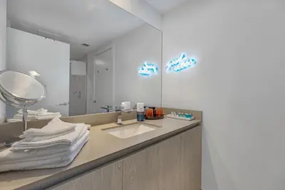 a bathroom with a sink and a mirror at The Ultimate Resort - BEACHFRONT 2 BEDROOM APARTMENT WITH DIRECT OCEAN VIEW, ROOFTOP POOL, HOT TUB AND GYM in Hollywood