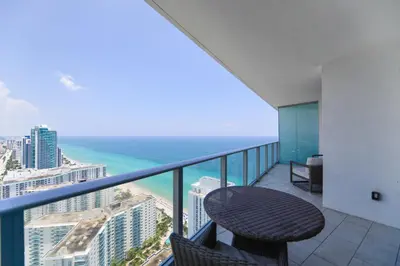 a balcony with a table and a view of the ocean at Iconic Ocean View - in this Stunning Condo in Hollywood